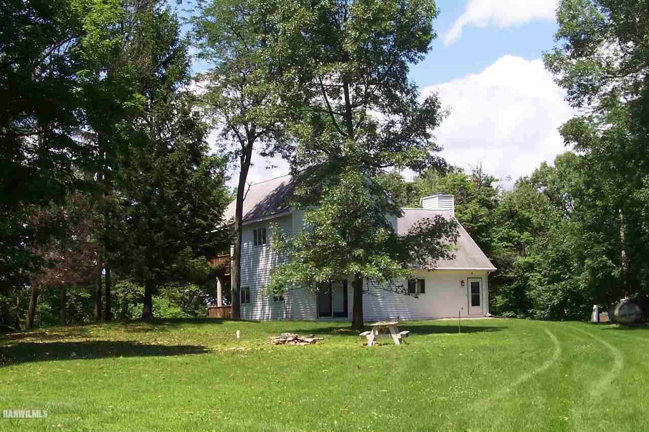 9293 West Diggin Hill Road Hanover, IL 61041 - Photo 9 of 19 a front view of a house with a garden and trees