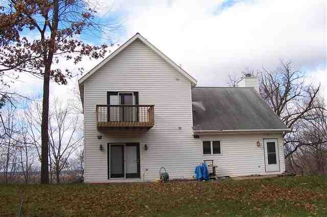 9293 West Diggin Hill Road Hanover, IL 61041 - Photo 10 of 19 a view of a house with large windows and a yard