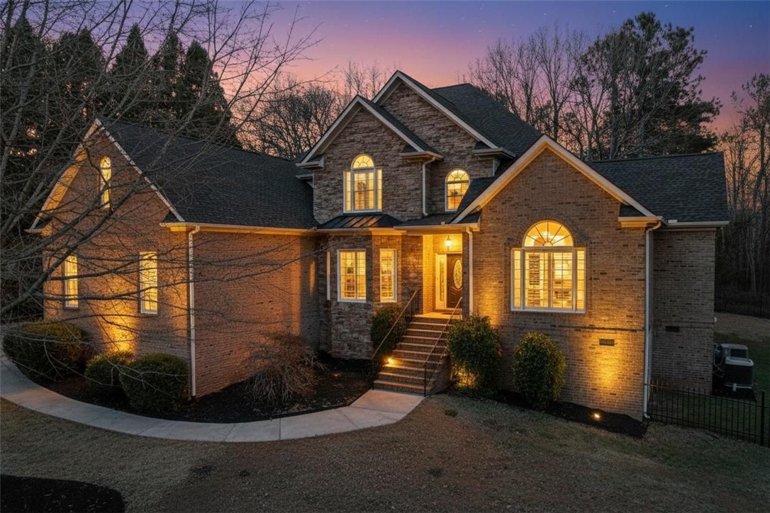 This charming home offers a brick exterior with stone accents, creating a warm and inviting appeal.