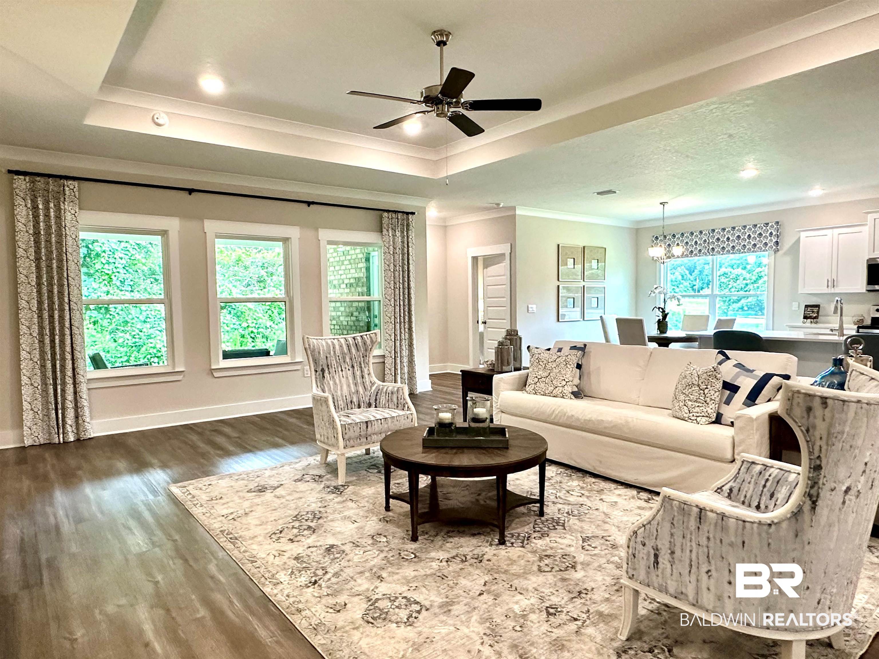 370 Barndling Street Fairhope, AL 36532 - Photo 9 of 30 Living room with a wealth of natural light, crown molding, and hardwood / wood-style floors