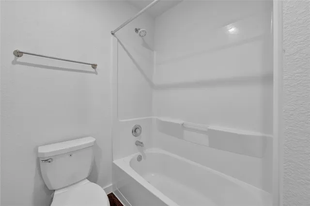 a bathroom with a toilet and a bathtub