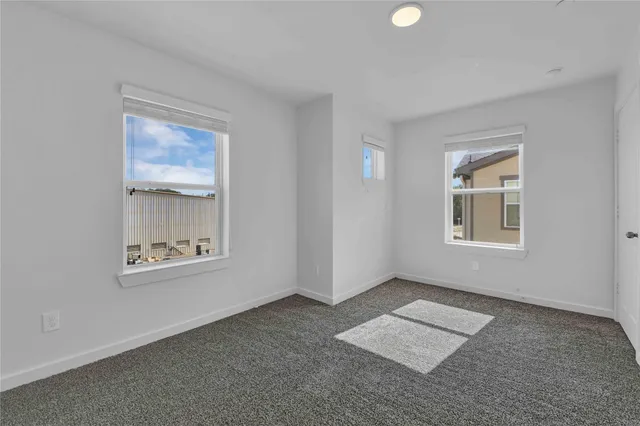 an empty room with windows and closet