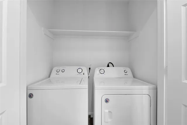 a view of storage and utility room with washer and dryer