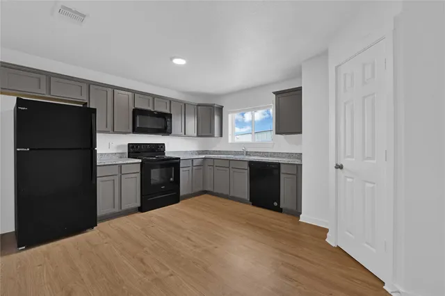 a kitchen with a refrigerator stove and microwave