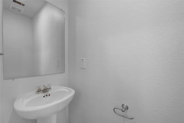 a bathroom with a sink and mirror