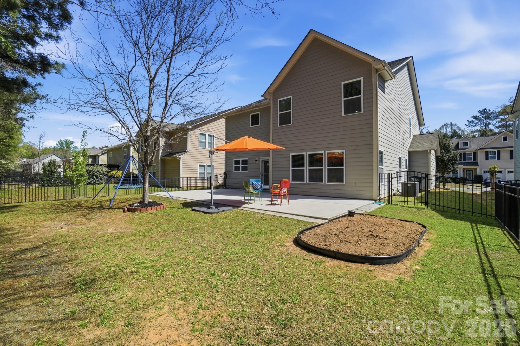 2153 Bluebell Way Tega Cay, SC 29708 - Photo 45 of 48 a view of a house with swimming pool and a yard