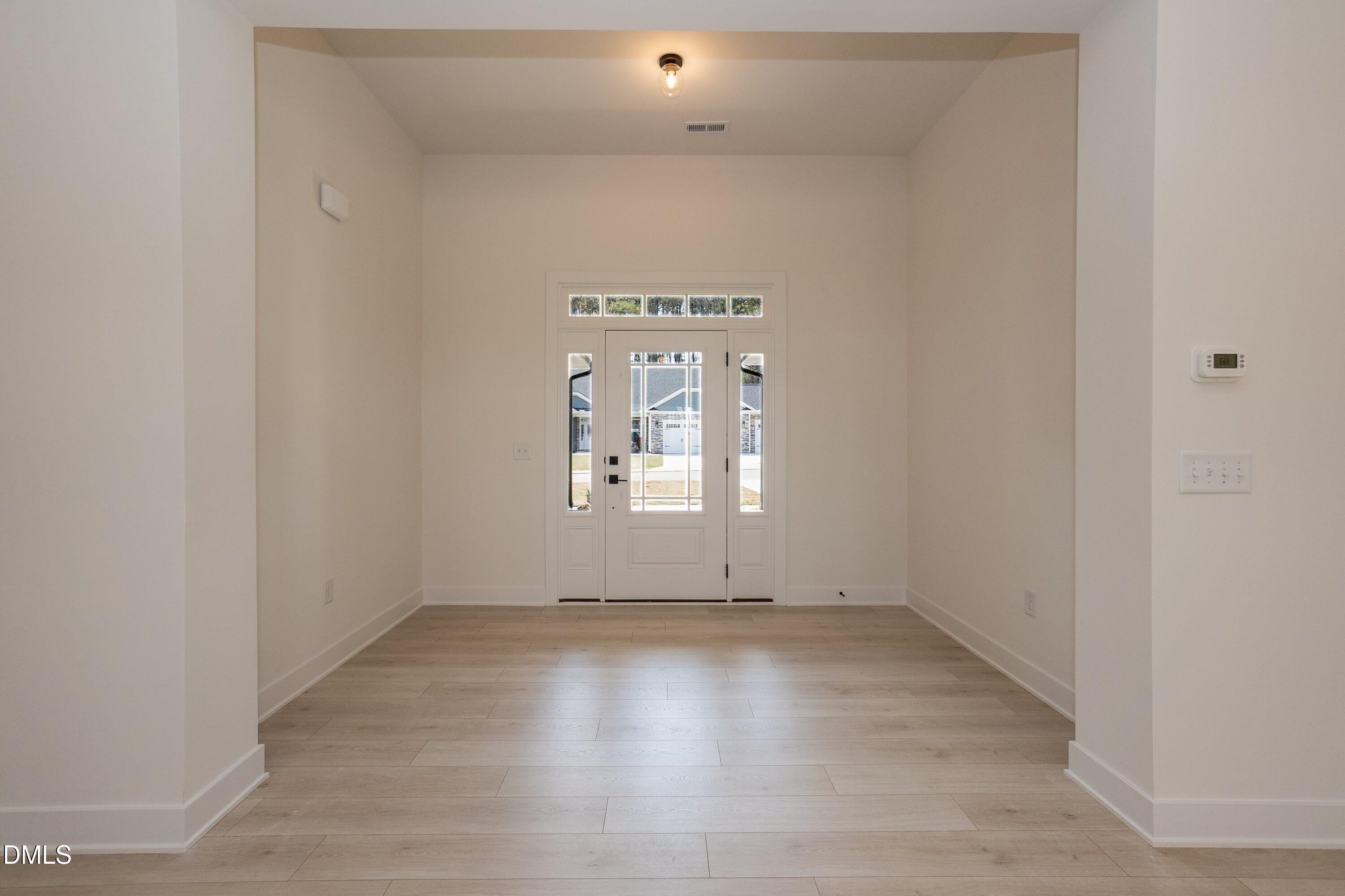 180 Galway Road Lillington, NC 27546 - Photo 9 of 41 an empty room with wooden floor and windows