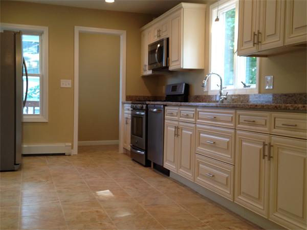 84 Eureka Street Worcester, MA 01603 - Photo 2 of 5 a kitchen with stainless steel appliances granite countertop a stove a sink and a refrigerator