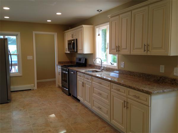 84 Eureka Street Worcester, MA 01603 - Photo 3 of 5 a kitchen with stainless steel appliances granite countertop a stove a sink and a refrigerator