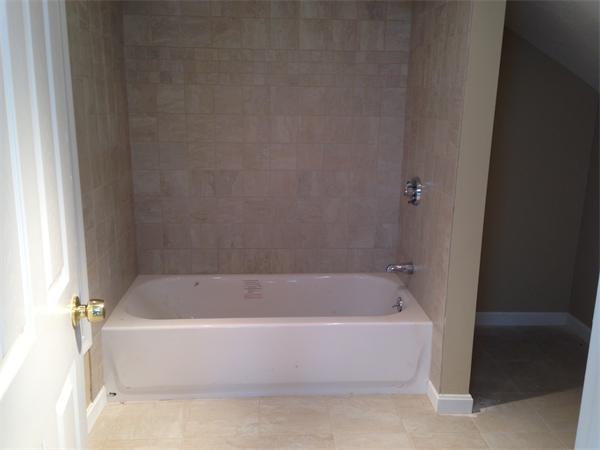 84 Eureka Street Worcester, MA 01603 - Photo 5 of 5 a white bath tub sitting in a bathroom