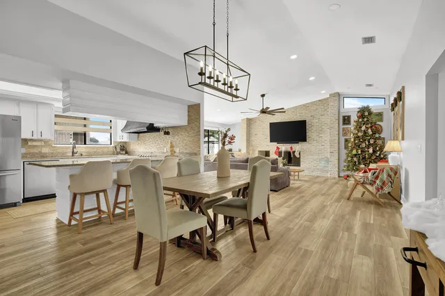 a view of a dining room with furniture and wooden floor