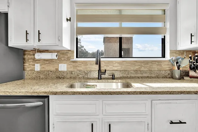 a utility room with sink dryer and washer