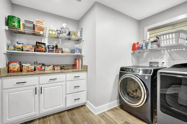 a view of a dining room with furniture wooden floor and chandelier
