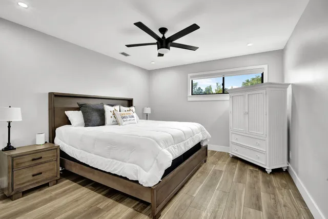 a bedroom with a bed and a chandelier