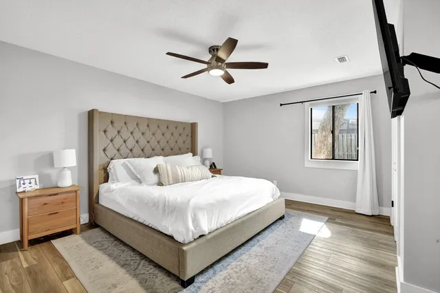 a bedroom with a bed and a flat screen tv