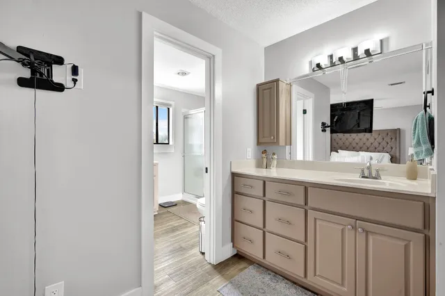 a spacious bathroom with a shower a sink and mirror