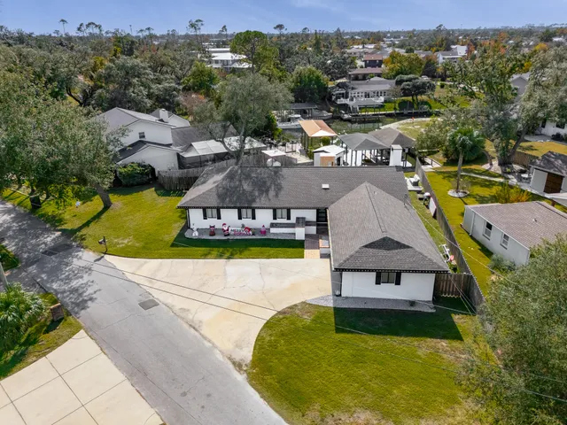 an aerial view of a house with swimming pool and patio