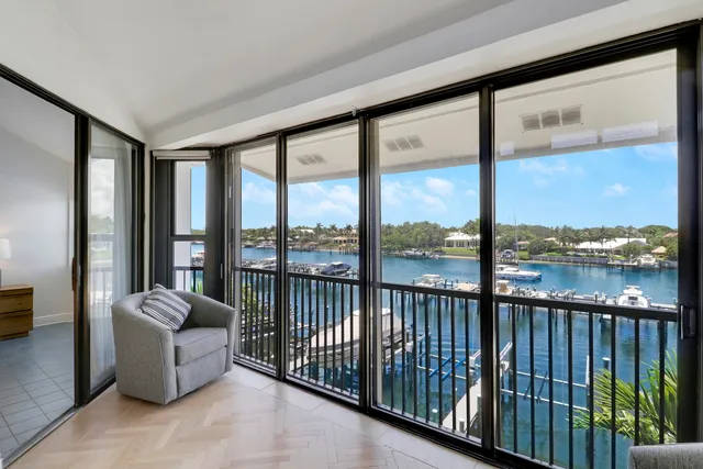 a bedroom with furniture and a large window