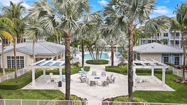 a view of a patio with table and chairs potted plants with wooden floor and fence