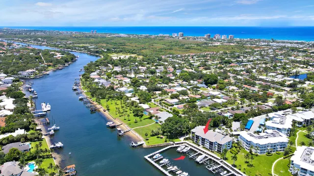a living room with furniture a flat screen tv and a floor to ceiling window
