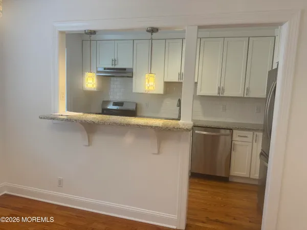 a kitchen with stainless steel appliances a sink and a refrigerator