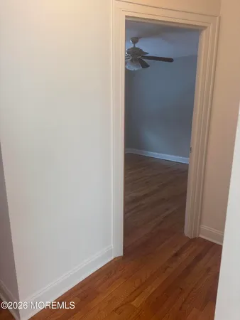 a view of walk in closet with wooden floor