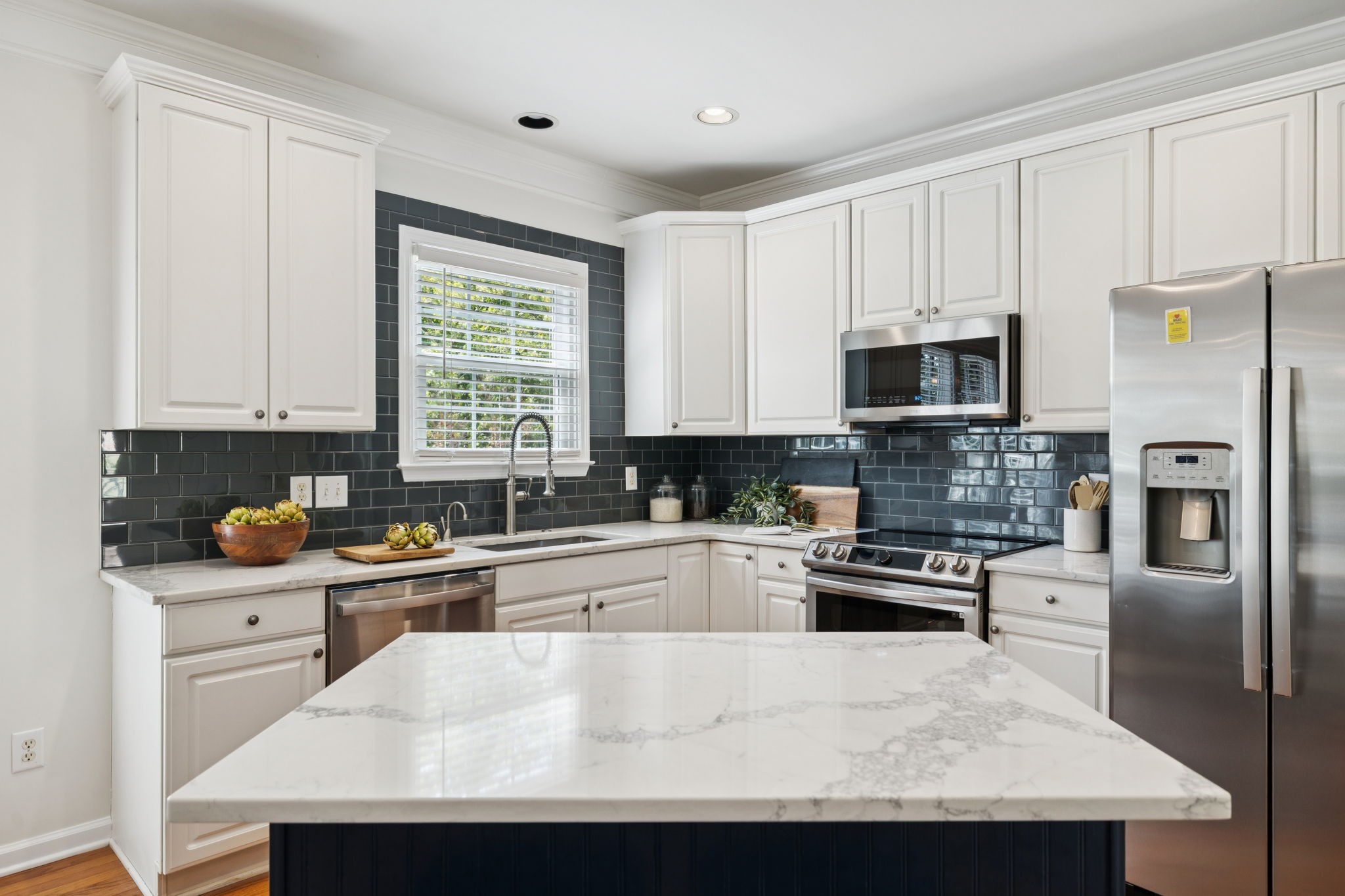 333 Springhouse Circle Franklin, TN 37067 - Photo 31 of 67 a kitchen with stainless steel appliances granite countertop a stove a sink a microwave a refrigerator and white cabinets