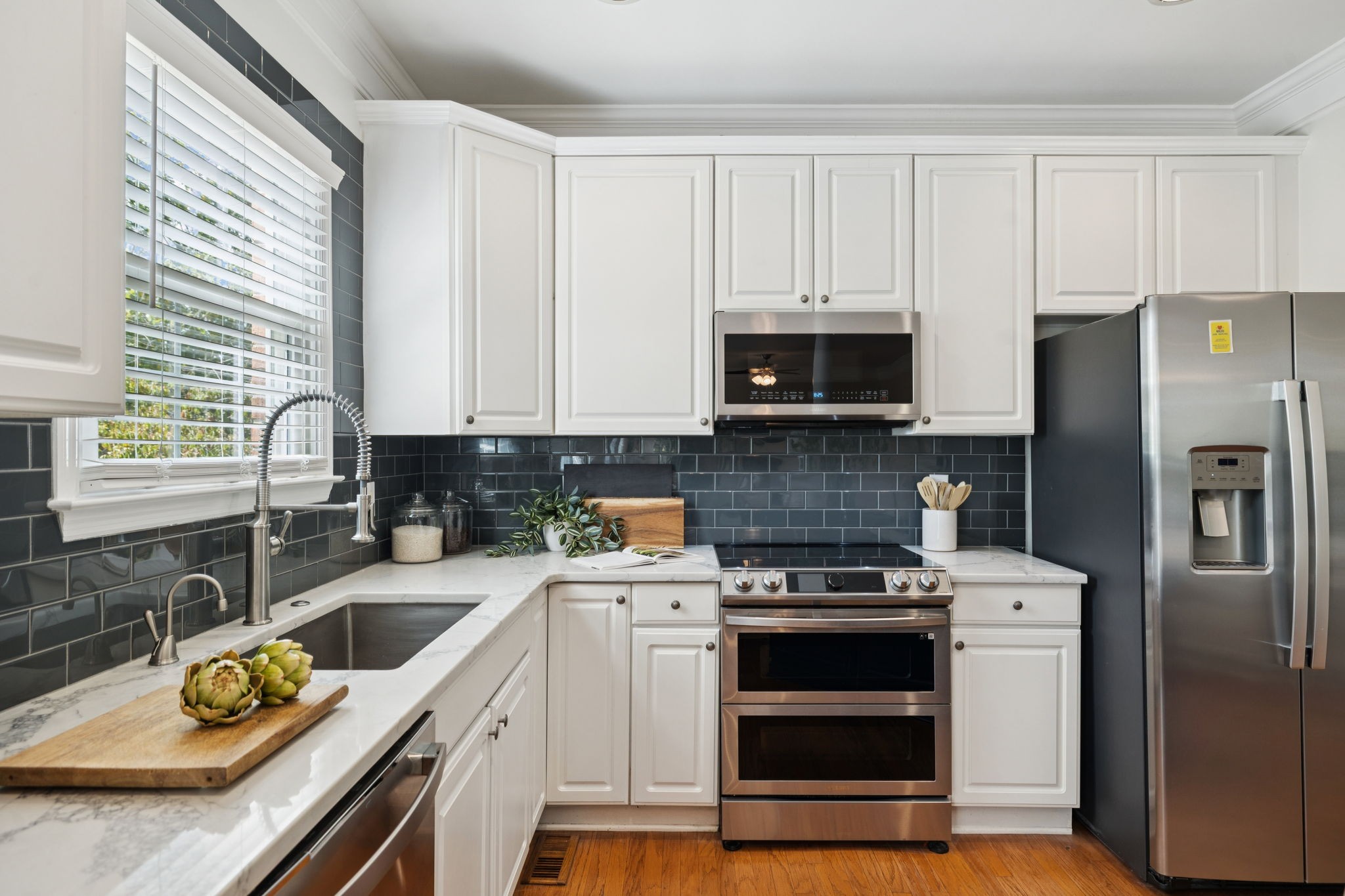333 Springhouse Circle Franklin, TN 37067 - Photo 32 of 67 a kitchen with a sink stove and microwave