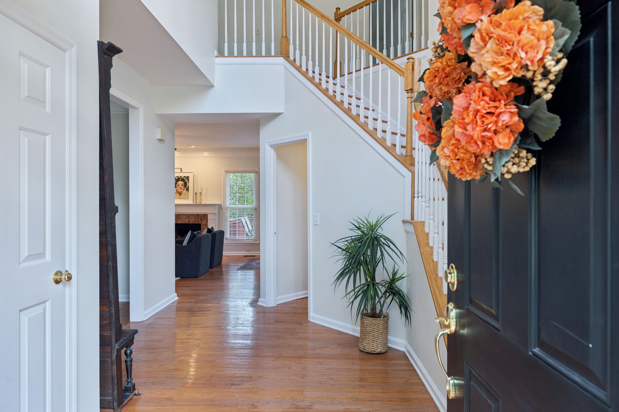 333 Springhouse Circle Franklin, TN 37067 - Photo 7 of 67 a hallway with a potted plant on a table and a potted plant