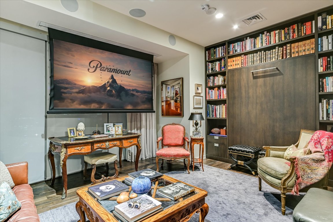 200 Congress Avenue, Unit 35AC Austin, TX 78701 - Photo 19 of 40 A home theater equipped with a drop-down screen, surround sound, and blackout curtains.