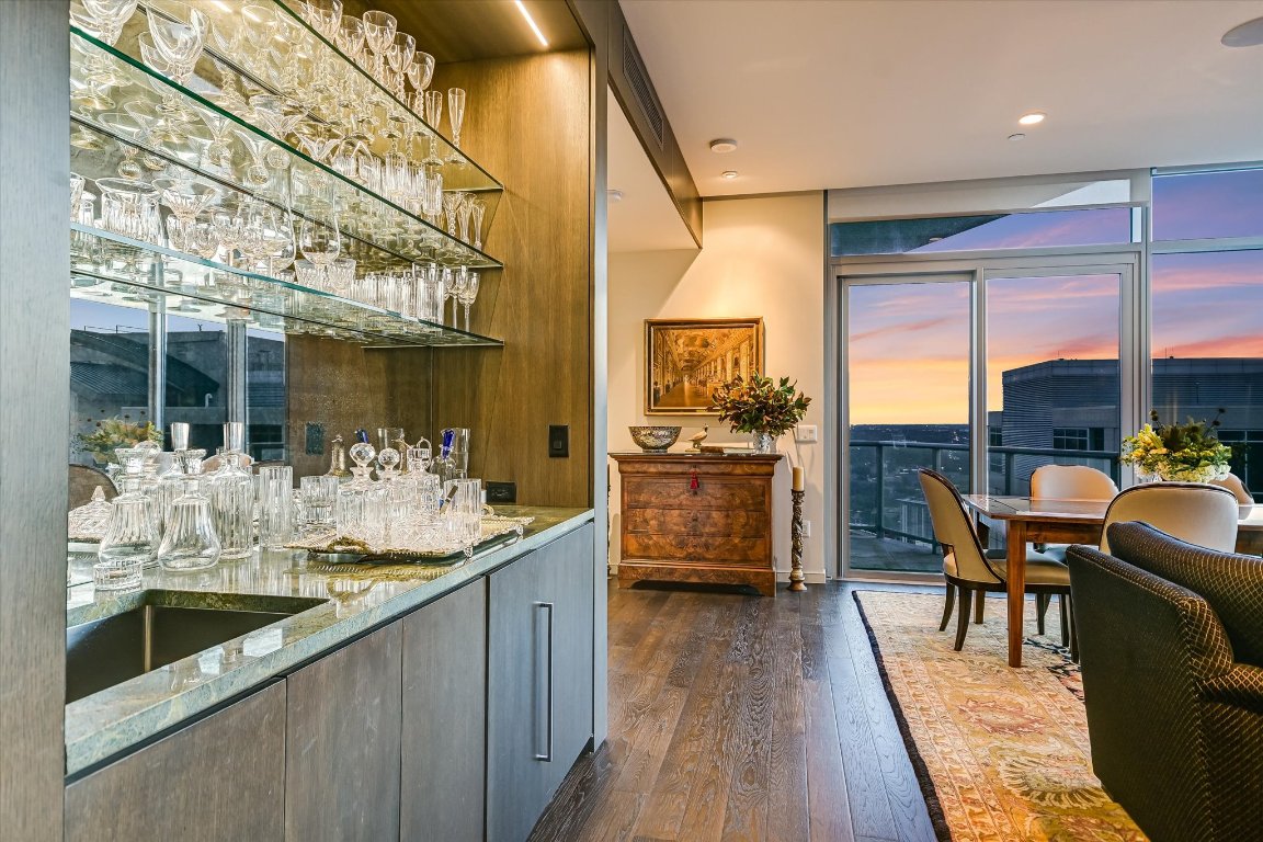 200 Congress Avenue, Unit 35AC Austin, TX 78701 - Photo 3 of 40 Separate bar area with a sink, beverage refrigerator, marble countertops & floating glass shelves.