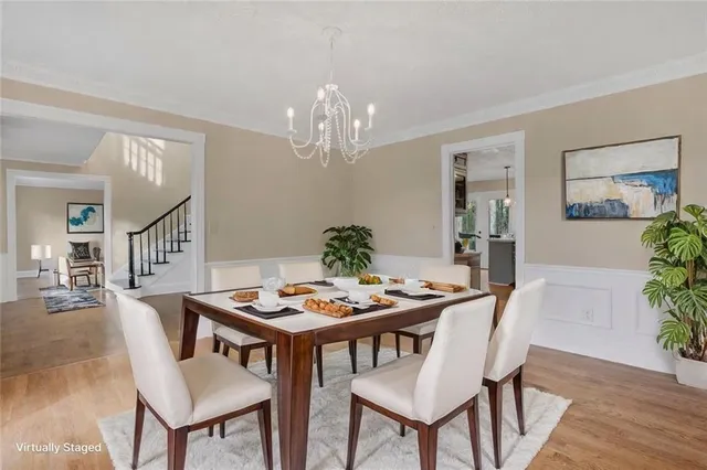 a kitchen with stainless steel appliances granite countertop a refrigerator a sink dishwasher a stove and a microwave oven with wooden floor