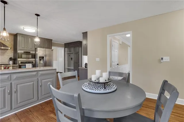 a bathroom with a granite countertop bathtub sink vanity mirror and toilet