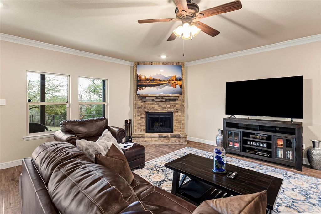 223 Cottongame Road Weatherford, TX 76088 - Photo 8 of 39 a living room with furniture and a flat screen tv