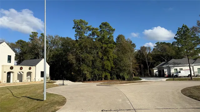 a view of street along with house and trees