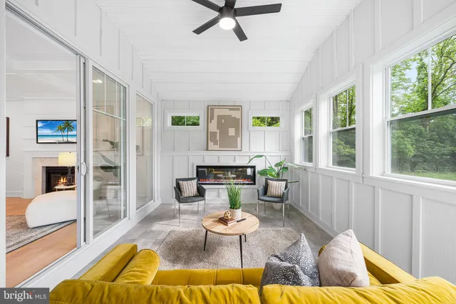 a kitchen with stainless steel appliances kitchen island granite countertop a refrigerator a stove a sink a dining table and chairs with wooden floor