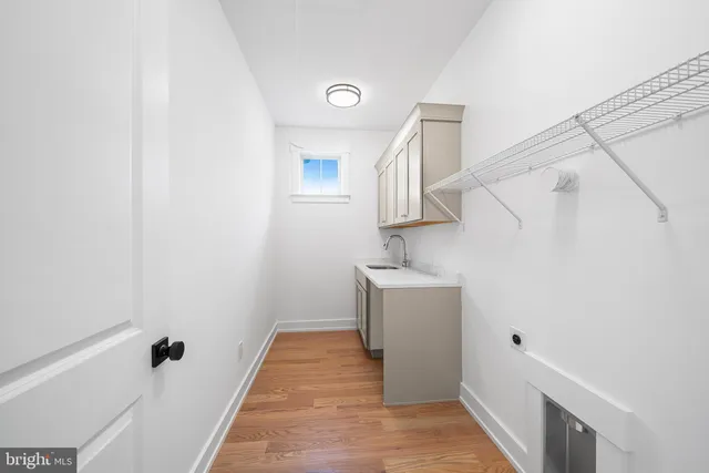 a view of a bedroom with wooden floor