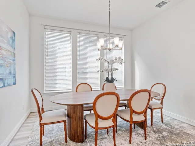 a spacious bedroom with a bed and a chandelier