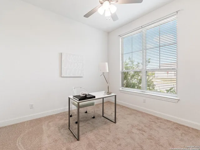 a spacious bedroom with a bed and a chandelier