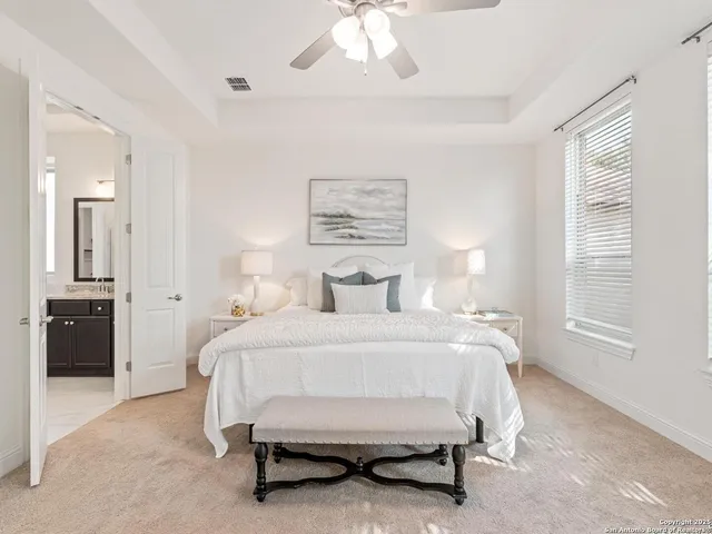 a bathroom with a bathtub a double vanity sink and mirror