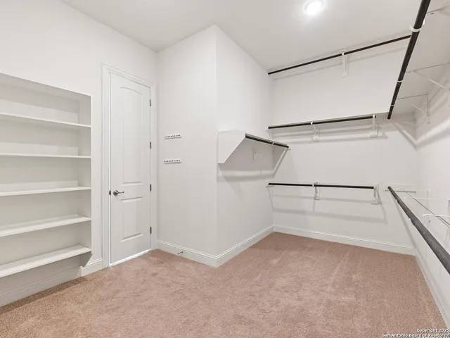 a view of kitchen with furniture and refrigerator