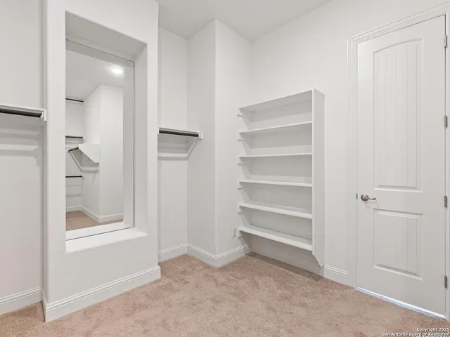 a view of a bedroom with wooden floor cabinet and a bathroom