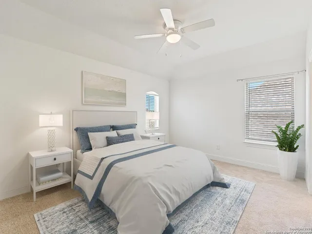 a bedroom with a large bed and a window