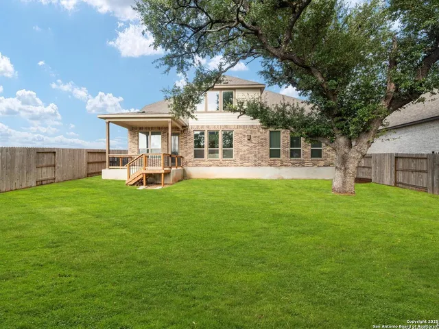 a view of a house with swimming pool and sitting area