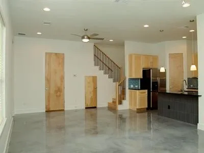 a view of a hallway with stainless steel appliances