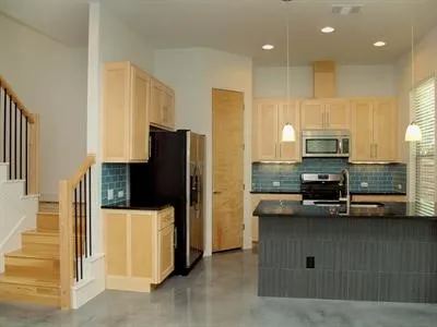 a kitchen with stainless steel appliances granite countertop a refrigerator and a stove