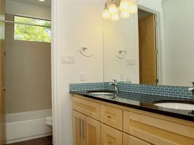 a bathroom with a sink a mirror and a shower