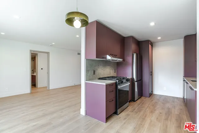a kitchen with stainless steel appliances granite countertop a stove and a refrigerator