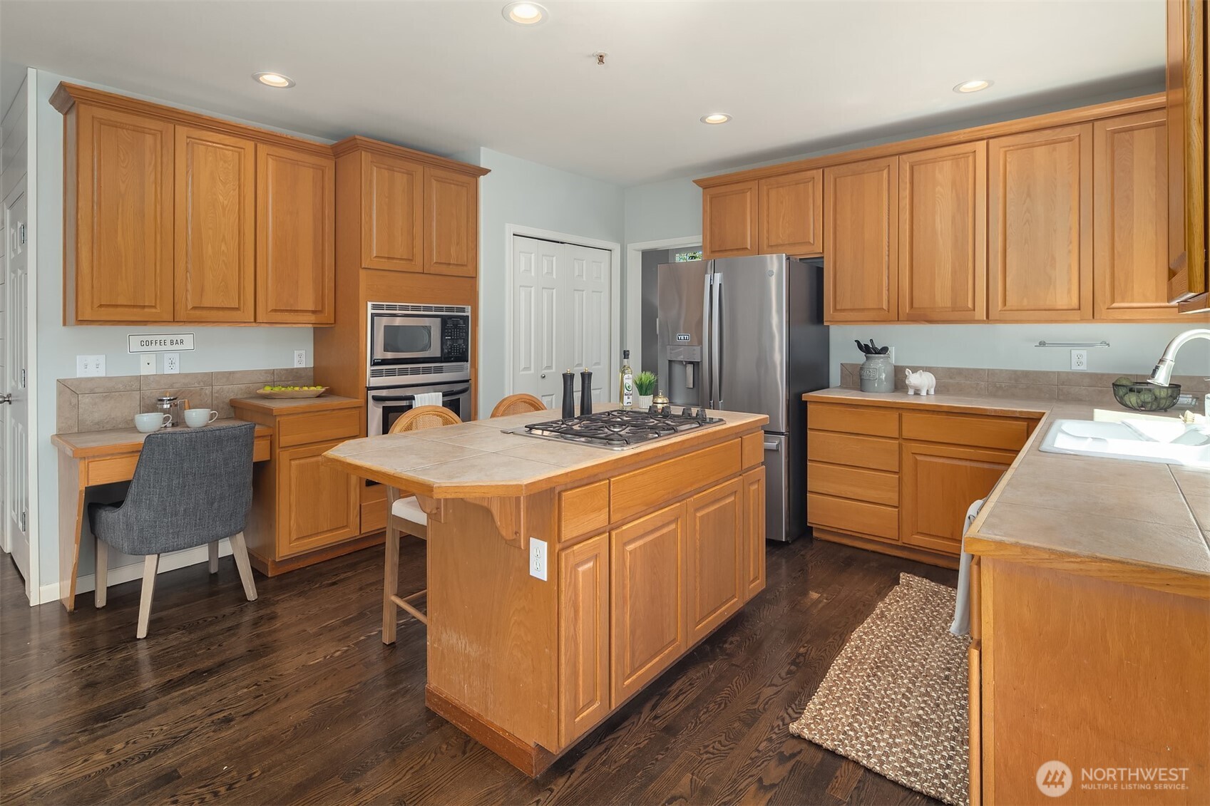 328 210 Street Southeast Bothell, WA 98021 - Photo 12 of 38 a kitchen with stainless steel appliances granite countertop a sink a stove and a refrigerator
