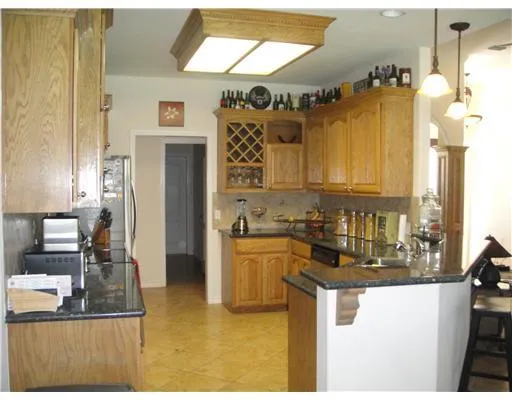a kitchen with a refrigerator and a stove